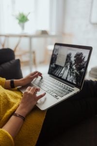 Kaboompics - Close-Up of Woman Using Laptop on Sofa, Cozy Remote Work Lifestyle