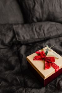 Kaboompics - Flat Lay of Wrapped Christmas Gifts on Dark Bedding