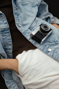 Kaboompics - Vintage Film Camera Resting On A Denim Jacket