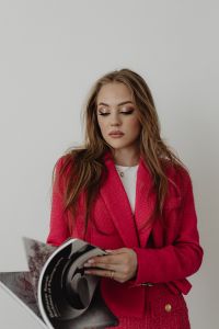 Kaboompics - Woman in Pink Skirt Suit Holding Fashion Books
