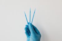 Kaboompics - Dental Microbrush Applicators in Blue Gloves With Copy Space