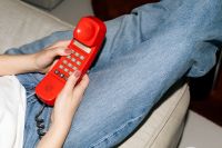 Kaboompics - Woman Holding Vintage Red Telephone Relaxed Home Lifestyle