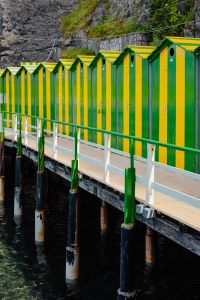 Kaboompics - Green And Yellow Italian Beach Huts Along A Wooden Seaside Walkway