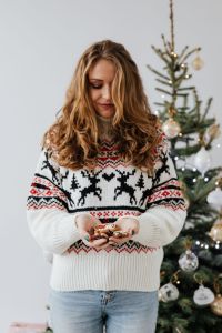 Kaboompics - Woman with Gingerbread Treats by Christmas Tree