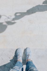Kaboompics - White Sneakers at Bottom of Pale Marble Steps with Curved Railing Shadows, Naples Italy Travel Detail