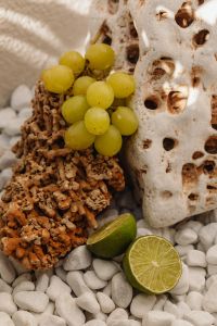 Kaboompics - Green Grapes and Lime on Natural Coral Rock