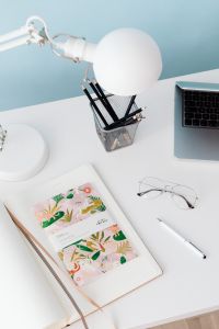 Kaboompics - Desk Lamp, Pencil Cup and Illustrated Planner with Glasses