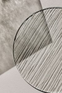 Kaboompics - Round Textured Glass Surface with Concentric Ridges on a Neutral Background