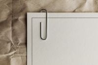 Kaboompics - Blank White Paper Mockup with Metal Paper Clip on Wrinkled Kraft Surface, Minimal Stationery Branding Background with Copy Space