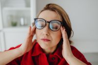 Kaboompics - Close-Up of Woman Resting Fingers at Temples with Eyes Closed, Desk Break