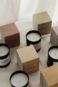 Kaboompics - Candle Collection and Neutral Boxes in Soft Light