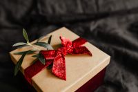 Kaboompics - Christmas Gifts and Joy Pillow on a Black Bedspread