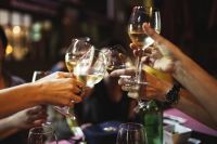 Kaboompics - People holding glasses of white wine making a toast