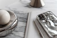 Kaboompics - Chrome Dome Lamp, Silver Phone and White Round Object on Arabescato Marble