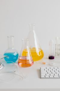 Kaboompics - Yellow and Orange Laboratory Flasks With Keyboard