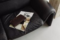 Kaboompics - Woven Handbag, Magazines and White Cup on a Sofa