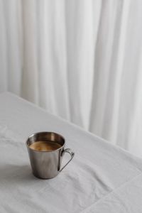 Kaboompics - Chrome Coffee Cup on White Fabric