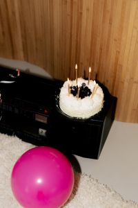Kaboompics - Nostalgic Birthday Cake with Candles and Pink Balloon
