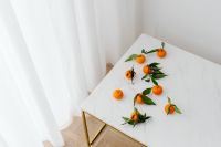 Kaboompics - Minimal Mandarin Still Life on White Marble Beside Sheer Curtains for Healthy Food Blog Backgrounds