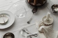 Kaboompics - White Christmas Table Setting with Cake, Taper Candle, Crystal Glass and Silver Cutlery