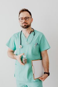 Kaboompics - Doctor With Pill Bottle and Medical Clipboard