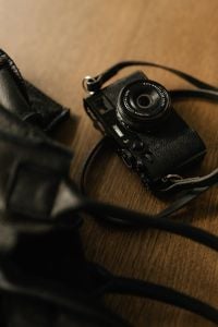 Kaboompics - Close-Up of Black Camera on Wooden Desk