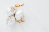 Kaboompics - Cluster of White and Gold Christmas Ornaments on Marble with Copy Space