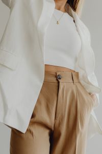 Kaboompics - Woman in White Shirt and Beige Trousers with Hand in Pocket
