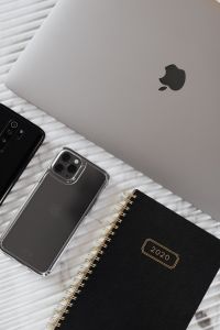 Kaboompics - Two Smartphones, Laptop and Black 2020 Planner in Vertical Tech Flat Lay