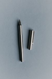Kaboompics - Minimal Fountain Pen and Cap on Blue Background