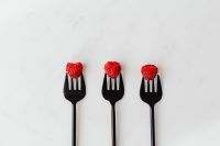 Kaboompics - Three Raspberries On Forks Close Up