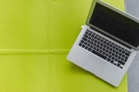 Kaboompics - Open Laptop on a Lime Green Lounge Chair