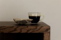 Kaboompics - Glass Espresso Cup and Natural Shell on Wooden Table
