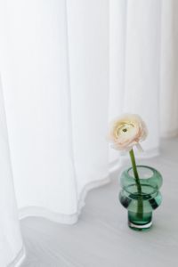 Kaboompics - White Ranunculus in a Green Glass Vase for Minimal Floral Styling