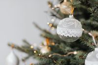 Kaboompics - White Lace Christmas Bauble among Evergreen Branches