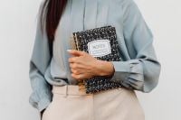 Kaboompics - Asian Woman Holding a Black Notes Notebook
