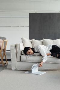 Kaboompics - Woman Reading on a White Linen Couch