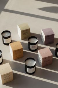 Kaboompics - Black Candles and Boxes in a Sunlit Product Setup