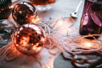 Kaboompics - Copper Christmas Baubles and Pearl Garland on a Festive Table