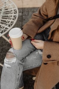 Kaboompics - Woman Holding Takeaway Coffee While Sitting in the City
