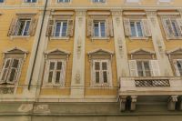 Kaboompics - Symmetrical Yellow Historic Facade with Shuttered Windows