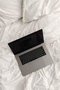 Kaboompics - Laptop Resting Diagonally on White Bed Linen