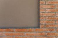 Kaboompics - Red Brick Wall with Dark Window Panel