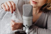 Kaboompics - Woman Handling Bubble Wrap beside Microphone for Relaxing ASMR Audio