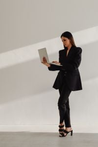 Kaboompics - Full-Body Businesswoman Working on a Laptop in a Black Suit