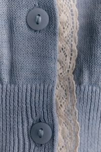 Kaboompics - Blue Knitted Clothing With Buttons and Cream Trim