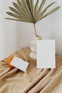 Kaboompics - Portrait Dried Flowers and Business Card Mockup with Orange on Beige Linen