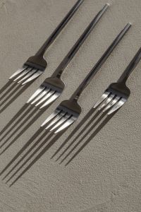 Kaboompics - Four Matte Steel Forks with Graphic Shadows on a Minimal Background