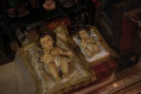 Kaboompics - Two Baby Jesus Figurines in Gold-Framed Glass Shop Display
