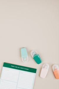 Kaboompics - Pastel Erasers beside Green Planner Card